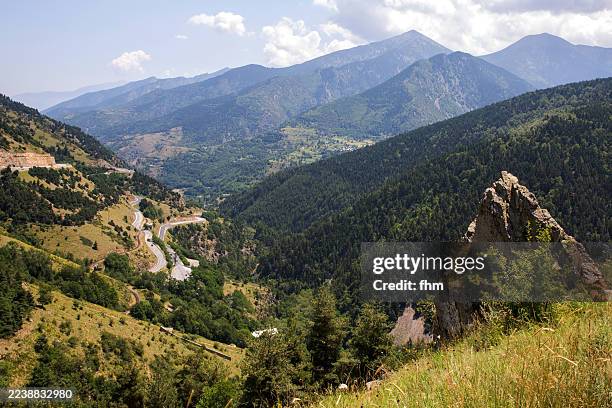 curvy road through the mountains of andorra - pirineos fotografías e imágenes de stock