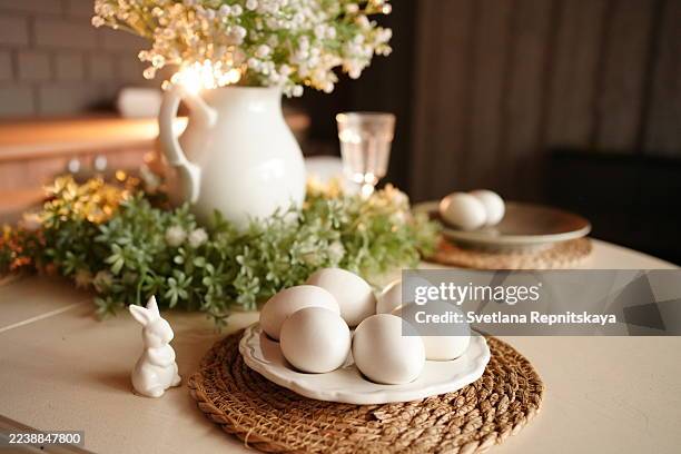 rustic easter table setting with white eggs and bunny figurine - easter breakfast stock pictures, royalty-free photos & images