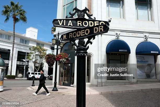 Pedestrian walks along Rodeo Drive on October 02, 2025 in Beverly Hills, California. According to the non-profit Visit California, international...