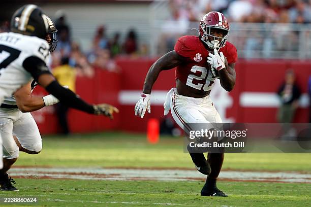 Jamarion Miller of the Alabama Crimson Tide carries the ball for a first down against the Vanderbilt Commodores during the fourth quarter of a...