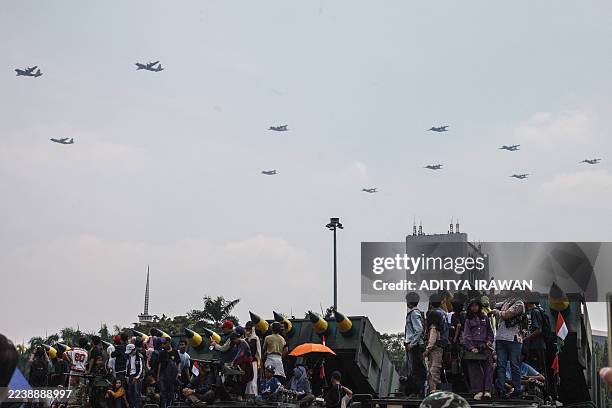 Indonesian Air Force C-130 transport aircraft fly past during a parade held as part of celebrations marking the 80th anniversary of the Indonesian...