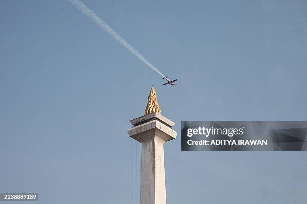 Plane of the Indonesian Air force's Jupiter aerobatic team flies past during a parade held as part of celebrations marking the 80th anniversary of...