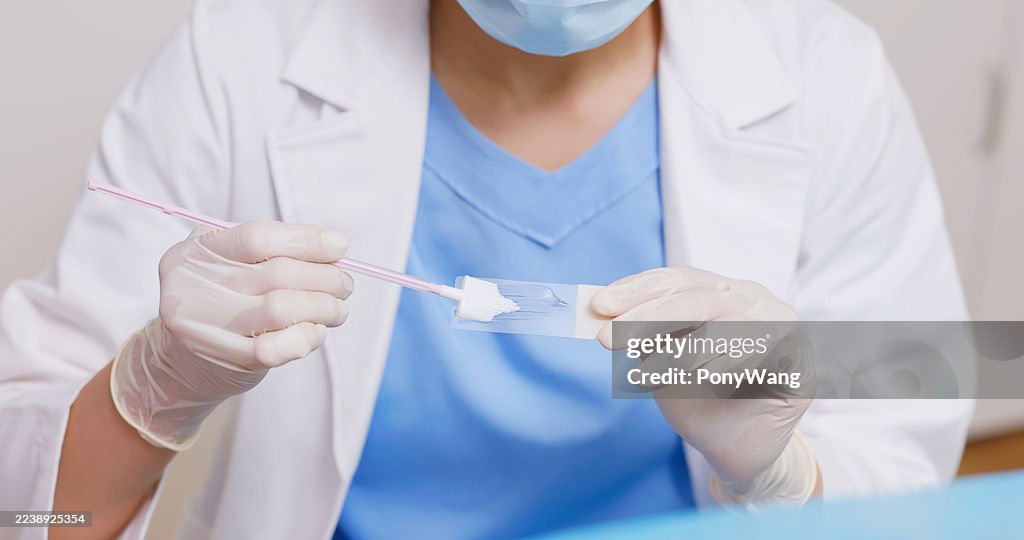 Placing cervical sample on glass slide