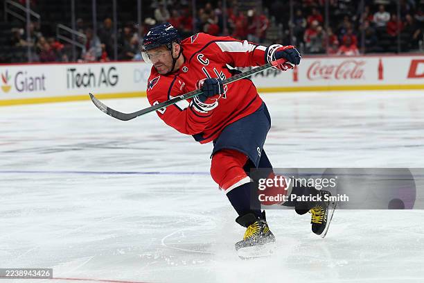 Alex Ovechkin of the Washington Capitals shoots the puck against the Boston Bruins in the second period during a preseason game at Capital One Arena...