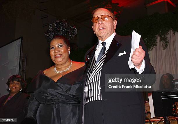 Clive Davis and singer Aretha Franklin speak on stage during Clive Davis' pre-Grammy Gala at the Regency Hotel's Grand Ballroom February 22, 2003 in...