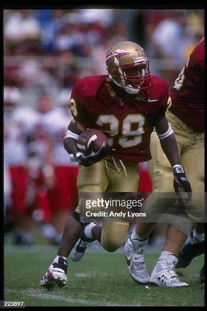 Running back Warrick Dunn of the Florida State Seminoles moves down the field during a game against the North Carolina State Wolfpack at...