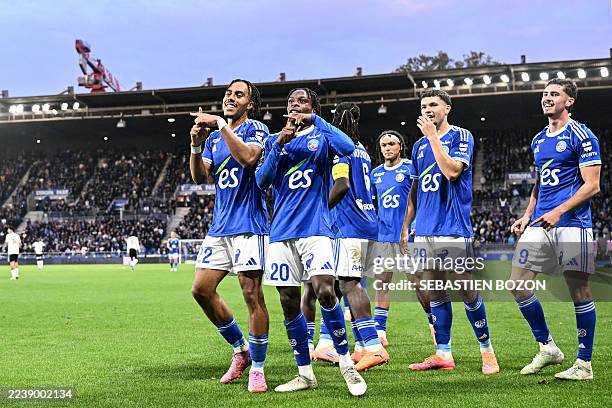 Strasbourg's Ivorian-British forward Martial Godo celebrates scoring his team's fourth goal with Strasbourg's Ivorian defender Guela Doue during the...