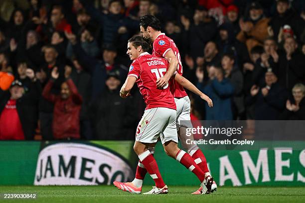 George Dobson of Wrexham celebrates scoring his team's first goal with teammate Kieffer Moore during the Sky Bet Championship match between Wrexham...