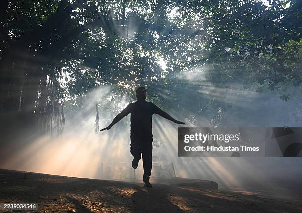 Man doing exercise after an NDMC fumigatus to prevent mosquito borne diseases at society, on October 5, 2025 in New Delhi, India.