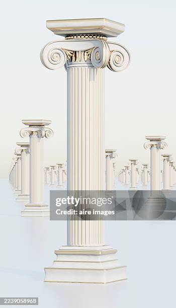 ionic columns in receding rows representing strength and history - ionic stock pictures, royalty-free photos & images