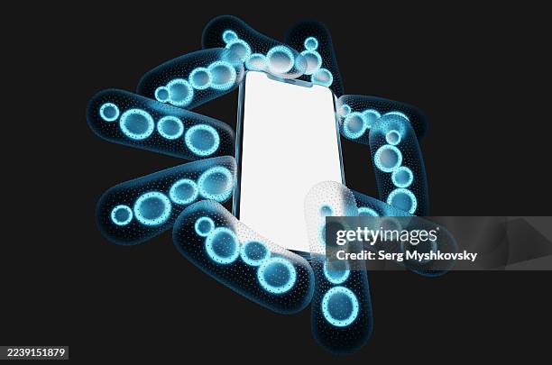 close-up of smartphone surrounded by glowing blue bacteria on black background - enterobacter aerogenes stock pictures, royalty-free photos & images