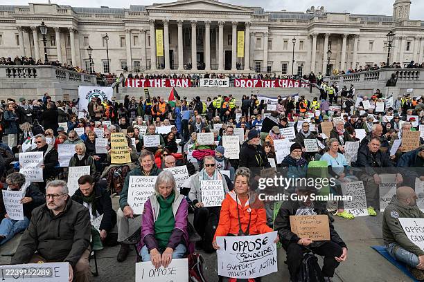 Activists defy the Palestine Action ban by holding illegal signs in Trafalgar Square on October 4, 2025 in London, England. Demonstrators are risking...