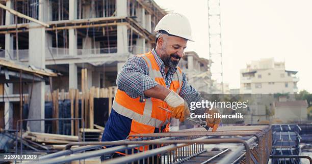 construction master wiring steel reinforcement cage for columns at construction site - pliers stock pictures, royalty-free photos & images