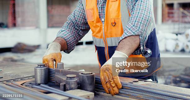 construction master wiring steel reinforcement cage for columns at construction site - structural steel construction stock pictures, royalty-free photos & images
