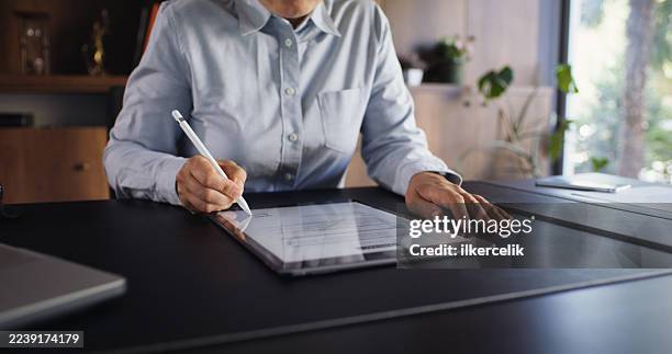 lawyer signing a digital document in the office using digital tablet - electronic documents stock pictures, royalty-free photos & images