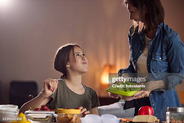 mother and daughter cooking together at home, preparing healthy snacks in a cozy kitchen today - salgadinhos stock pictures, royalty-free photos & images