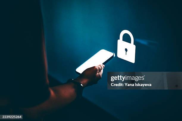 cybersecurity digital display with smartphone and locked padlock icon in dark setting - one-armed-person-handicapped-person stock pictures, royalty-free photos & images