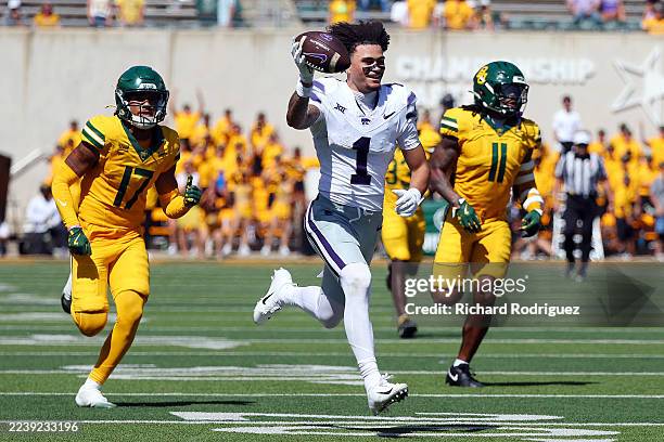 Jayce Brown of the Kansas State Wildcats runs with the ball after losing his helmet in the fourth quarter against the Baylor Bears at McLane Stadium...