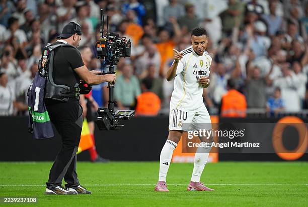 Kylian Mbappe of Real Madrid celebrates into a TV camera after scoring his team's third goal during the LaLiga EA Sports match between Real Madrid CF...