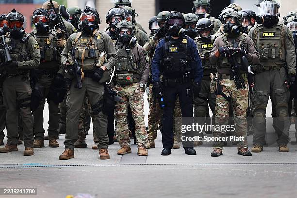 Federal agents, including members of the Department of Homeland Security, the Border Patrol, and police, clash with protesters outside a downtown...