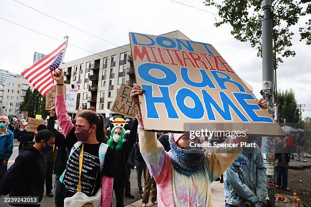 Protesters gather outside of a downtown U.S. Immigration and Customs Enforcement facility on October 04, 2025 in Portland, Oregon. The facility has...