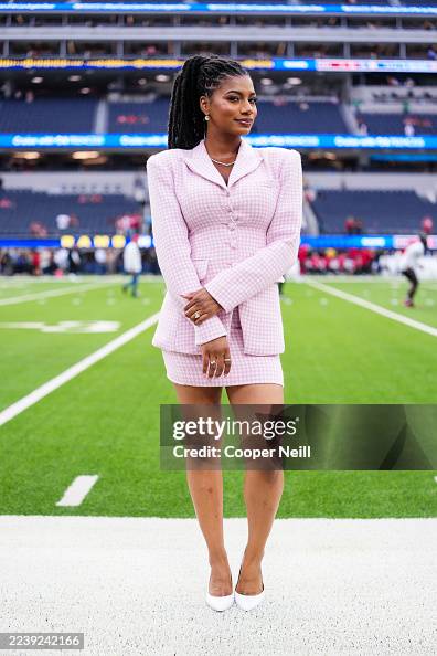 Tyler Rooks Style Taylor Rooks looks on from the field prior to an NFL football game ...