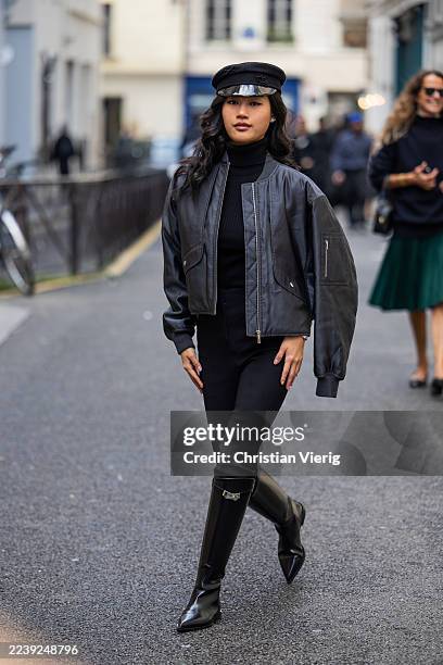 Jihoo Kim wears flat cap, black leather bomber jacket, pants, knee high boots outside Hermes during the Womenswear Spring Summer 2026 as part of...