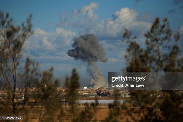Smoke rises over the Gaza Strip after an Israeli bombardment as seen from a position near the Kfar Aza kibbutz on October 7, 2025 in Kfar Aza,...