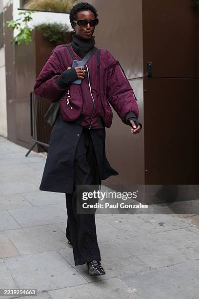 Guest is seen wearing a burgundy blouson outside the Johanna Parv show, during London Fashion Week on September 21, 2025 in London, England.