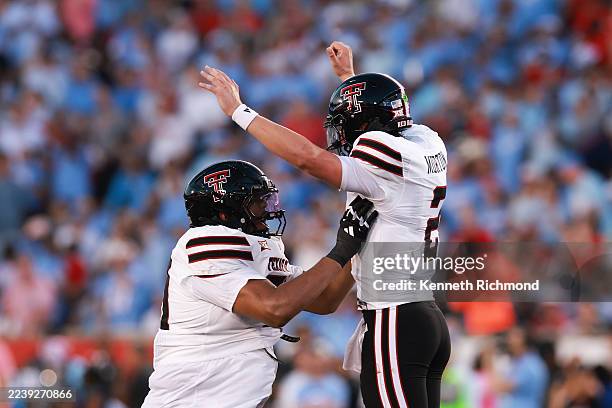 Behren Morton of the Texas Tech Red Raiders celebrates after throwing a touchdown in the second quarter against the Houston Cougars at TDECU Stadium...