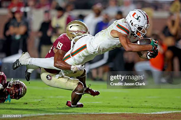 Daniels of the Miami Hurricanes scores a touchdown in the third quarter at the end of a 26-yard run while Jerry Wilson of the Florida State Seminoles...