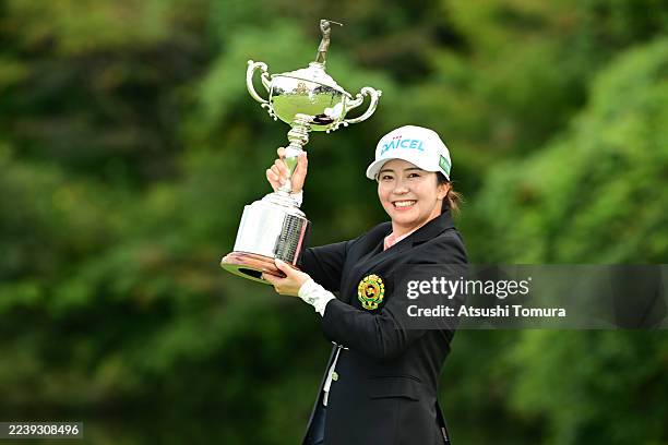 Kotone Hori of Japan poses with the trophy after winning the tournament following the final round of the Japan Women's Open Golf Championship at...