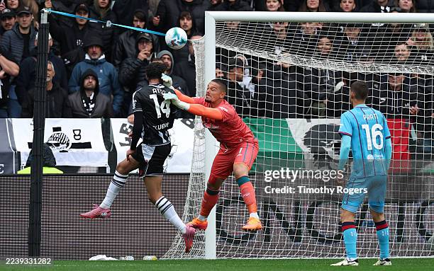 Arthur Atta of Udinese heads the ball on to the crossbar as Elia Caprile of Cagliari attempts a save during the Serie A match between Udinese Calcio...