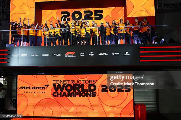 The McLaren team celebrate winning the 2025 F1 World Constructors Championship on the podium during the F1 Grand Prix of Singapore at Marina Bay...