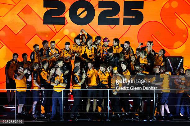 The McLaren team celebrate winning the 2025 F1 World Constructors Championship on the podium during the F1 Grand Prix of Singapore at Marina Bay...
