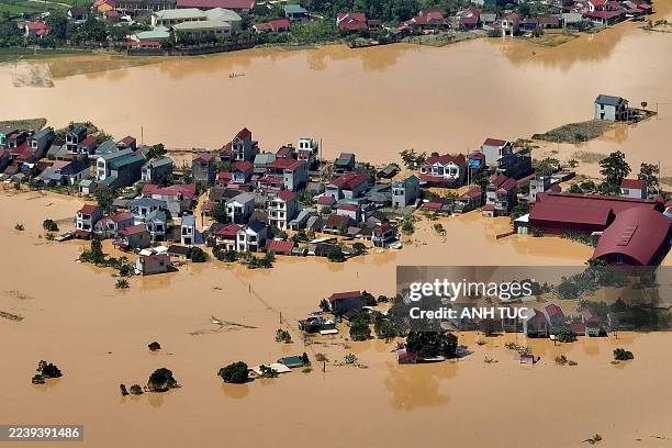 This aerial photo shows a flooded village in That Khe commune after heavy rains caused by Typhoon Matmo in Lang Son province on October 8, 2025....
