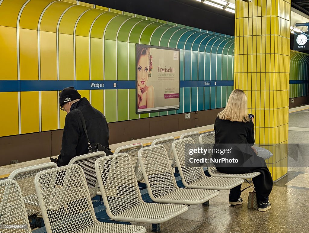 Passengers Using Smartphones At Metro Station