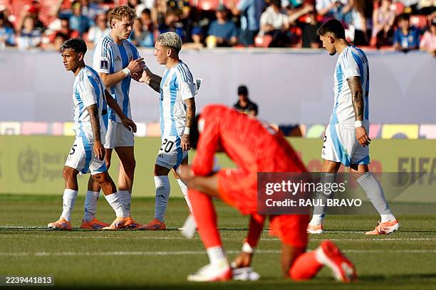 Argentina's midfielder Milton Delgado, Argentina's defender Valente Pierani and Argentina's forward Gianluca Prestianni celebrate their victory at...