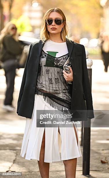 Guest is seen wearing a Lacoste blazer, white and green Lacoste shirt, black sheer top, white sheer skirt and black sunglasses outside the Lacoste...