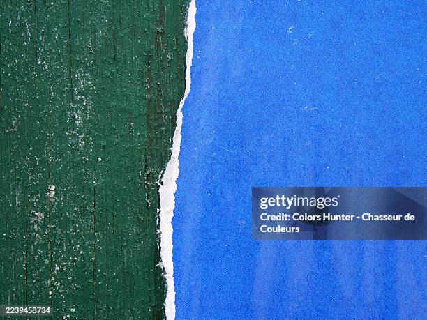 close-up of a torn blue poster stuck on a green wooden panel. rough texture. sunlight. natural colors and patina. full frame 4:3.manhattan, new york state, united states. - green paper texture stock pictures, royalty-free photos & images