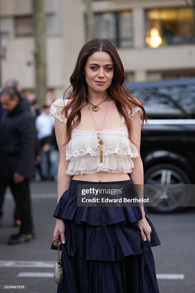Spring Parted Molly Gordon wears long wavy brown hair parted in the center, gold ...