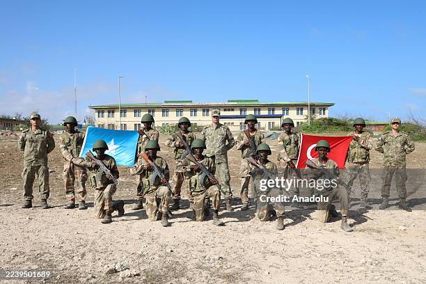 Somali soldiers pose with Turkish and Somali flags during military training at the TURKSOM Military Training Base in Mogadishu, Somalia on August 25,...