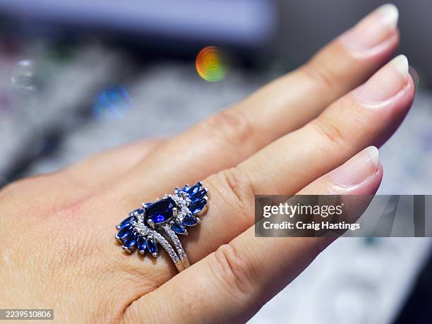 elegant hand with blue sapphire and diamond accent ring - sapphire stock pictures, royalty-free photos & images