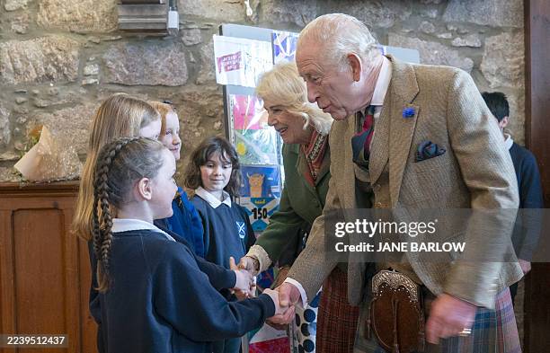 Britain's Queen Camilla and Britain's King Charles III meet pupils from Ballater School during a visit to mark the 150th anniversary of The Albert...