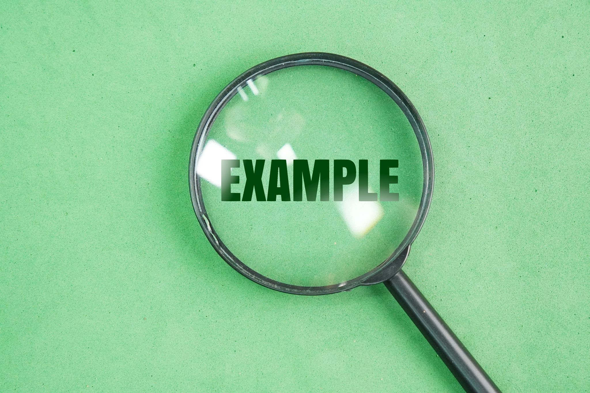 magnifying glass with example words and green background. magnifying glass with example words and green background.
