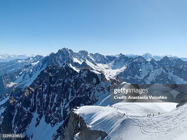 aerial view of climbers and skiers on snowy slopes in the french alps - mont blanc stock pictures, royalty-free photos & images