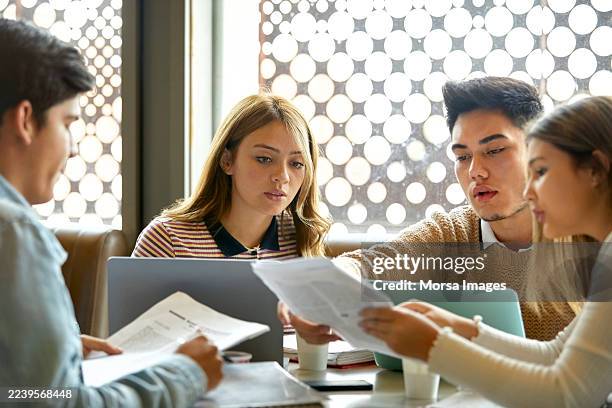 students discussing over paper in university - classroom laptop stock pictures, royalty-free photos & images