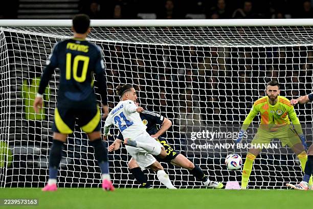 Greece's defender Kostas Tsimikas shoots to score the team's first goal during the 2026 World Cup Group C qualifier football match between Scotland...