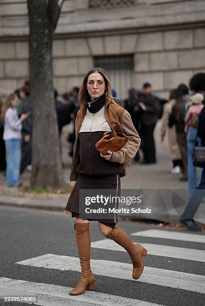 Ann-Kathrin Götze, attending the Miu Miu show during Paris Fashion Week Spring/Summer 2026, is seen wearing a two-tone zip-up bomber jacket in...