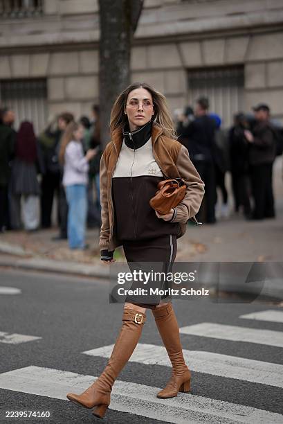 Ann-Kathrin Götze, attending the Miu Miu show during Paris Fashion Week Spring/Summer 2026, is seen wearing a two-tone zip-up bomber jacket in...